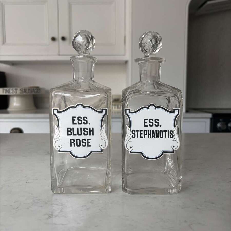Pair of Edwardian Glass Perfumery Bottles with Painted Enamel Labels. Excellent Condition.