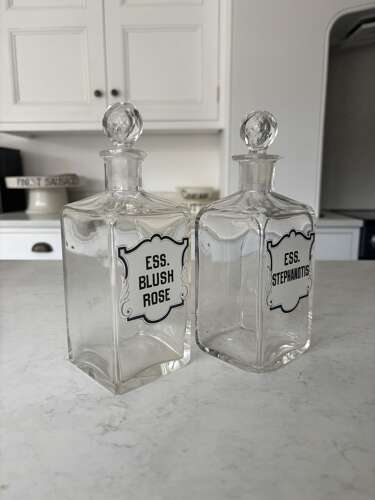 Pair of Edwardian Glass Perfumery Bottles with Painted Enamel Labels. Excellent Condition.