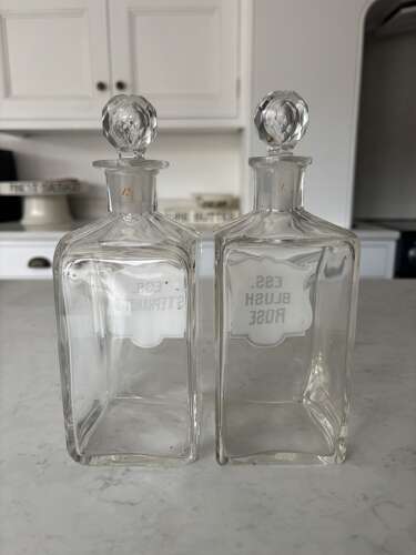 Pair of Edwardian Glass Perfumery Bottles with Painted Enamel Labels. Excellent Condition.